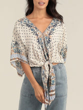 Load image into Gallery viewer, Ivory kimono sleeve tie front top with blue floral boho print, paired with light wash jeans - 4
