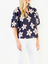 Load image into Gallery viewer, Navy floral puff sleeve top with white and red flower print, V-neck, paired with white pants - 6
