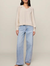 Load image into Gallery viewer, Stratton V-neck cream knit sweater with raglan detail and ribbed hem paired with light wash jeans - 2

