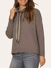 Load image into Gallery viewer, Woman wearing taupe cable knit cowl neck lightweight sweater with satin tie detail and long sleeves paired with jeans - 1
