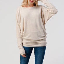 Load image into Gallery viewer, Women's oatmeal brushed dolman top with batwing sleeves and banded hem, paired with blue skinny jeans - 3
