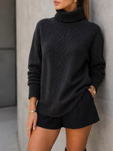 Load image into Gallery viewer, Black textured turtleneck oversized sweater with ribbed cuffs and hem, styled with black mini shorts - 1
