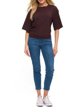 Load image into Gallery viewer, Woman wearing oversized brown ruched waist short sleeve tee paired with blue skinny jeans - 2
