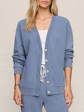 Load image into Gallery viewer, Dazed End Knit Denim Cardigan in Santorini Indigo blue with button front, ribbed cuffs, worn open over white tank top - 1

