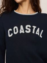 Load image into Gallery viewer, Woman wearing navy blue Coastal Sienna Sweater in Eclipse with white letter graphic and cream denim shorts - 4
