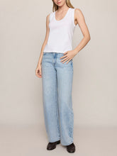 Load image into Gallery viewer, Ellie white v-neck sleeveless tank top styled with light wash wide-leg jeans on female model - 3
