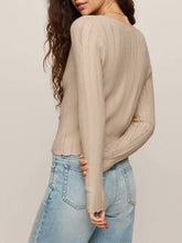 Load image into Gallery viewer, Woman wearing Landa Sweater Top in Natural, beige ribbed knit button-front crop cardigan with V-neck and blue jeans - 3
