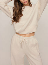 Load image into Gallery viewer, Woman wearing cream oversized Clubhouse Sweatshirt in Cloud with matching drawstring sweatpants, cozy loungewear set - 3
